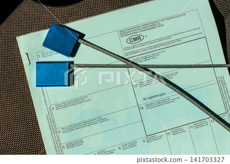 Plastic security seals with metal wires lying on delivery documents Plastic security seals with metal wires lying on delivery documents 141703327