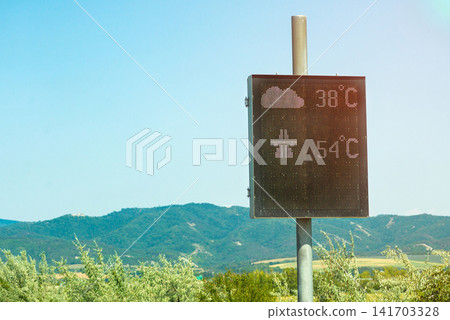 Metal boundary sign pole standing next to a rural road field Metal boundary sign pole standing next to a rural road field 141703328