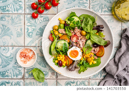 Tuna salad with tomatoes , olives , eggs and onion . Tuna salad with tomatoes , olives , eggs and onion . 141703550