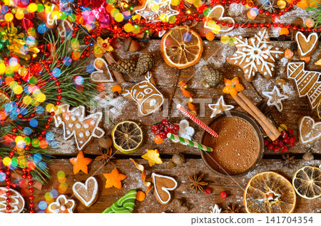 Seasonal cookies arranged in varied shapes. Icing designs showcase diverse winter shapes. Celebration and cooking concept with christmas decoration and gingerbread cookies on wooden background. Seasonal cookies arranged in varied shapes. Icing designs showcase diverse winter shapes. Celebration and cooking concept with christmas decoration and gingerbread cookies on wooden background. 141704354