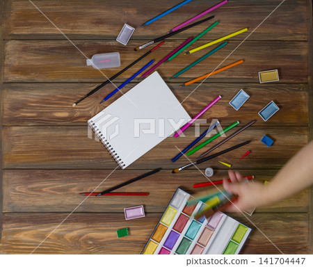 Clipboard mockup and art school stationery on a wooden background. Mock up for text. 141704447