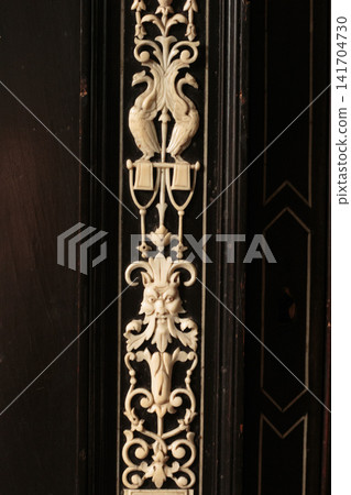 Antique Ivory Inlay Relief Ornament with Human Face Mask on Dark Wood Antique Ivory Inlay Relief Ornament with Human Face Mask on Dark Wood 141704730