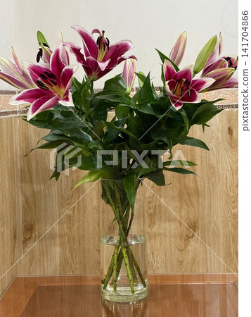 Elegant Oriental Lily Bouquet in Glass Vase Indoors Elegant Oriental Lily Bouquet in Glass Vase Indoors 141704866