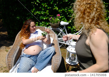 Pregnant woman enjoying a peaceful outdoor maternity lifestyle portrait Pregnant woman enjoying a peaceful outdoor maternity lifestyle portrait 141705008