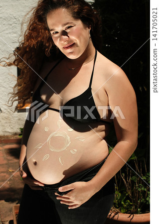 Pregnant woman enjoying a peaceful outdoor maternity lifestyle portrait Pregnant woman enjoying a peaceful outdoor maternity lifestyle portrait 141705021
