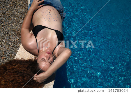 Pregnant woman enjoying a peaceful outdoor maternity lifestyle portrait Pregnant woman enjoying a peaceful outdoor maternity lifestyle portrait 141705024