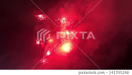 Red Fireworks Display in Night Sky Red Fireworks Display in Night Sky 141705298