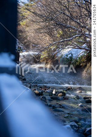 A snow-covered stream and rising steam A snow-covered stream and rising steam 141705634