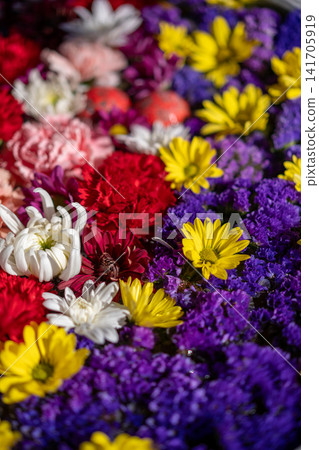The vibrant colors of the flower arrangement in the water basin The vibrant colors of the flower arrangement in the water basin 141705919