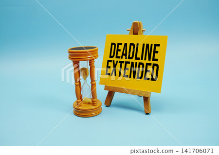 Deadline Extended text with hourglass on blue background Deadline Extended text with hourglass on blue background 141706071