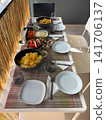 Snack table set on a cozy balcony with chips and appetizers 141706137