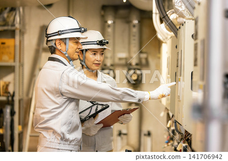 workers working in a factory workers working in a factory 141706942