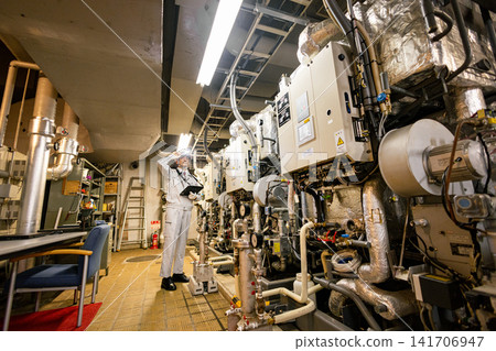 Senior male worker inspecting equipment in the boiler room Senior male worker inspecting equipment in the boiler room 141706947
