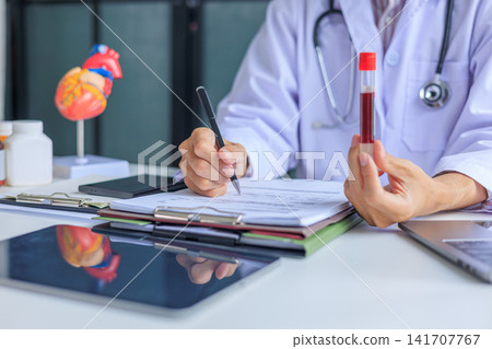 Medical worker checking biochemistry blood screening report on desk. Medical worker checking biochemistry blood screening report on desk. 141707767