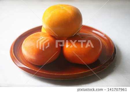 Autumn fruit: Delicious-looking persimmons Autumn fruit: Delicious-looking persimmons 141707961