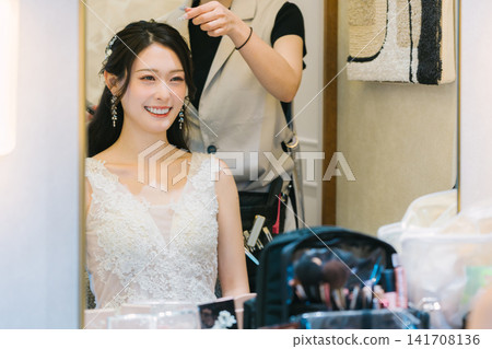Bride getting her makeup done in the bridal room - wedding 141708136