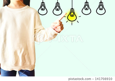 A glowing light bulb and a little girl A glowing light bulb and a little girl 141708910