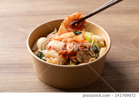 Eating instant noodle soup with kimchi, bok choy, champignon mushroom, quail egg and Tteokbokki Eating instant noodle soup with kimchi, bok choy, champignon mushroom, quail egg and Tteokbokki 141709072