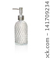 Clear glass perfume bottle with a diamond pattern on a white background. 141709234