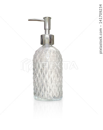 Clear glass perfume bottle with a diamond pattern on a white background. Clear glass perfume bottle with a diamond pattern on a white background. 141709234