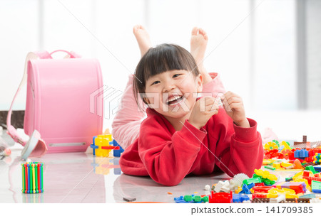 Cute Asian Child Girl Playing with Colorful Plastic Building Blocks on Floor, Creative Educational Toys for Early Development, Toddler Having Fun at Home Cute Asian Child Girl Playing with Colorful Plastic Building Blocks on Floor, Creative Educational Toys for Early Development, Toddler Having Fun at Home 141709385