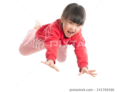 Excited little girl in red sweater reaching forward and shouting with excitement, energetic play. Excited little girl in red sweater reaching forward and shouting with excitement, energetic play. 141709386