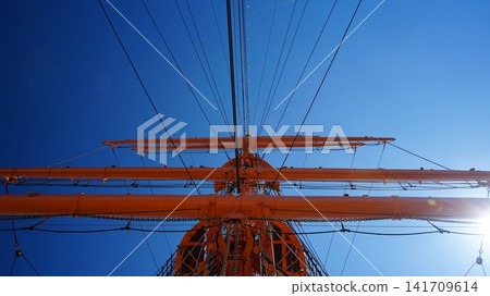 A mast, a transmission tower, a ship, soaring into the blue sky A mast, a transmission tower, a ship, soaring into the blue sky 141709614