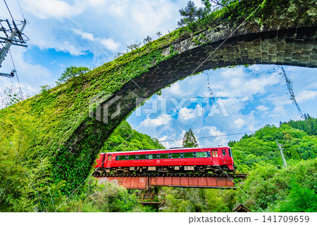 The Kyushu Trans-Island Express train (Asaji to Bungo-Taketa) speeds past the Sasamuta Stone Arch Bridge on the Hohi Main Line. The Kyushu Trans-Island Express train (Asaji to Bungo-Taketa) speeds past the Sasamuta Stone Arch Bridge on the Hohi Main Line. 141709659