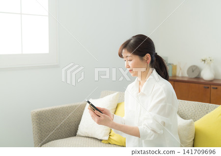 middle woman using smartphone middle woman using smartphone 141709696