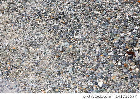 Small stones scattered across the riverbed Small stones scattered across the riverbed 141710557