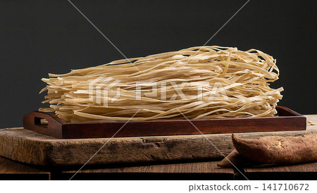 uncooked Flat Sweet Potato Noodles Starch Vermicelli Close Up uncooked Flat Sweet Potato Noodles Starch Vermicelli Close Up 141710672
