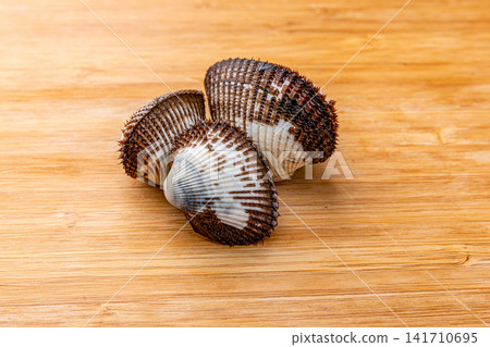 fresh raw blood clams with ridged shells in close up fresh raw blood clams with ridged shells in close up 141710695