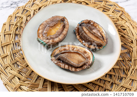 fresh raw sea abalone with green shell intact fresh raw sea abalone with green shell intact 141710709