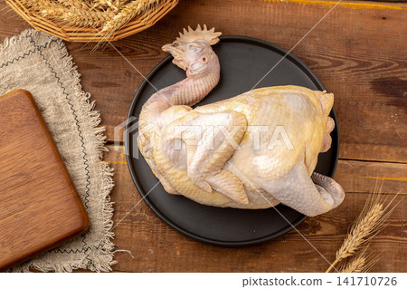 raw whole free-range heritage chicken ready for roasting 141710726