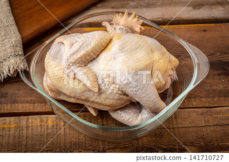 raw whole free-range heritage chicken ready for roasting 141710727