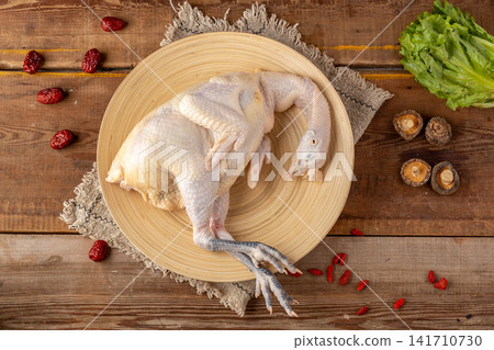 raw whole free-range heritage chicken ready for roasting 141710730