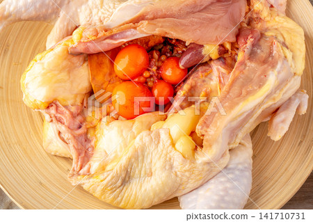 raw whole free-range heritage chicken ready for roasting 141710731