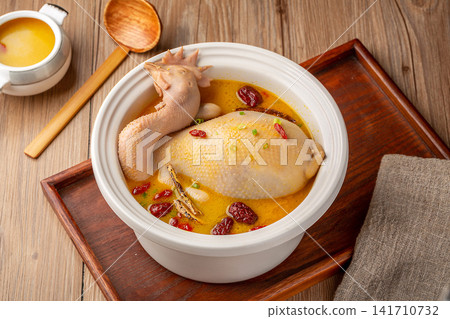 simmered whole chicken soup with traditional herbs and dates simmered whole chicken soup with traditional herbs and dates 141710732