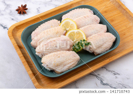 raw chicken mid wings prepared for cooking and grilling raw chicken mid wings prepared for cooking and grilling 141710743