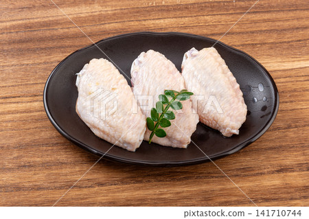 raw chicken mid wings prepared for cooking and grilling raw chicken mid wings prepared for cooking and grilling 141710744