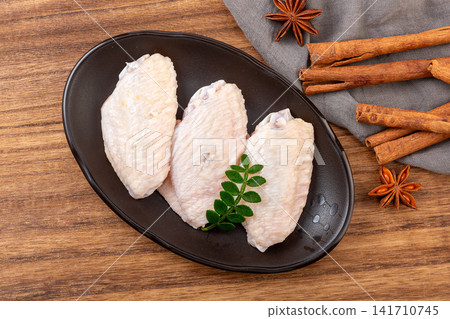 raw chicken mid wings prepared for cooking and grilling raw chicken mid wings prepared for cooking and grilling 141710745