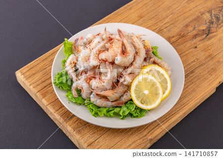 raw headless small sea shrimps with shells intact for cooking 141710857