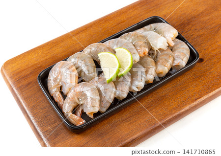 raw headless tail-on white prawns cleaned for culinary preparation raw headless tail-on white prawns cleaned for culinary preparation 141710865