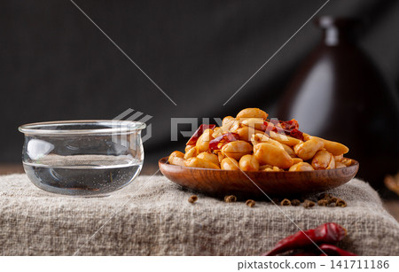 spicy roasted peanuts with chili peppers packed in sealed container spicy roasted peanuts with chili peppers packed in sealed container 141711186