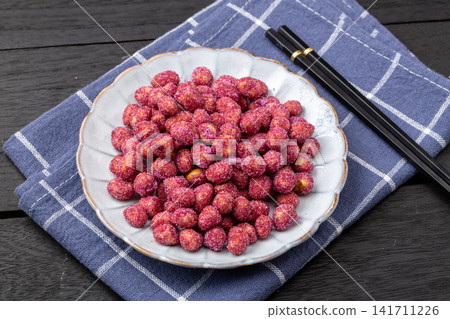 purple coated crispy peanuts served in small plate purple coated crispy peanuts served in small plate 141711226