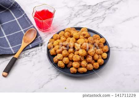 golden crispy coated peanuts served on plate golden crispy coated peanuts served on plate 141711229