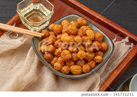 golden crispy coated peanuts served on plate 141711231