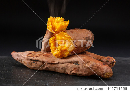roasted orange sweet potatoes broken open roasted orange sweet potatoes broken open 141711366
