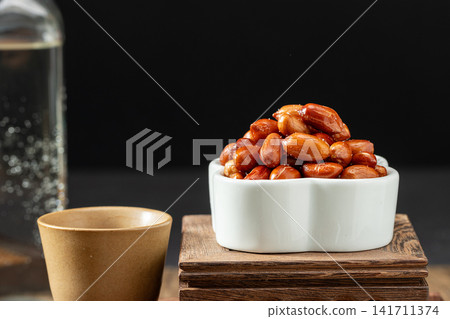 deep fried peanuts served in a hexagonal plate with chopsticks deep fried peanuts served in a hexagonal plate with chopsticks 141711374