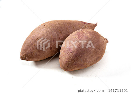 whole raw purple sweet potatoes on background whole raw purple sweet potatoes on background 141711391